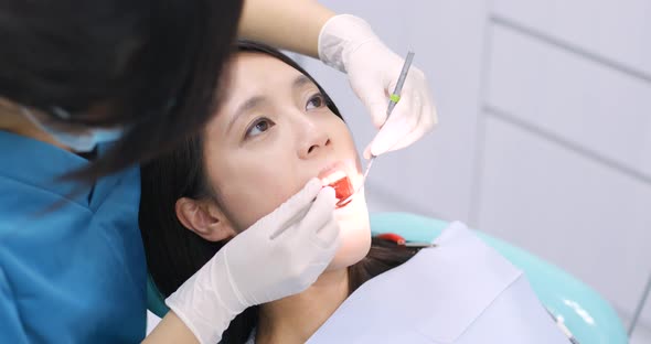 Woman doing check up in dental office