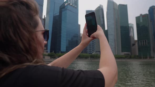 Woman Is Taking Photo and Video By Smartphone of Skyscrapers