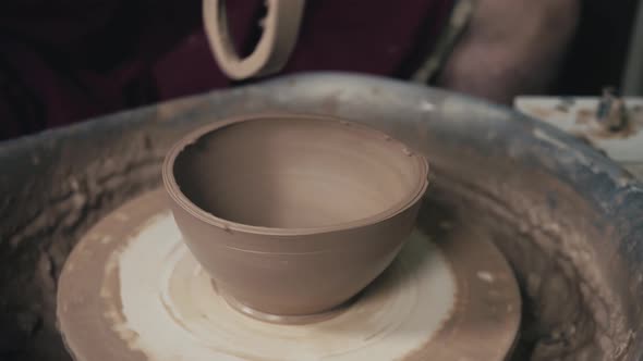 Hands of the Master Potter and Vase of Clay on the Potter's Wheel Closeup