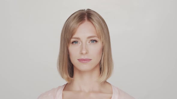 Studio portrait of young, beautiful and natural blond woman.