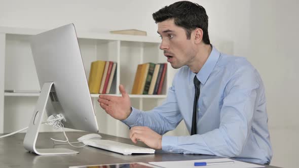 Businessman in Shock While Working on Computer