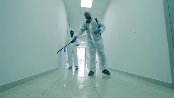 White Corridor Is Getting Chemically Sanitized By the Specialists