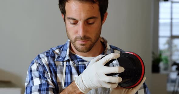 Male photographer cleaning lens cover 