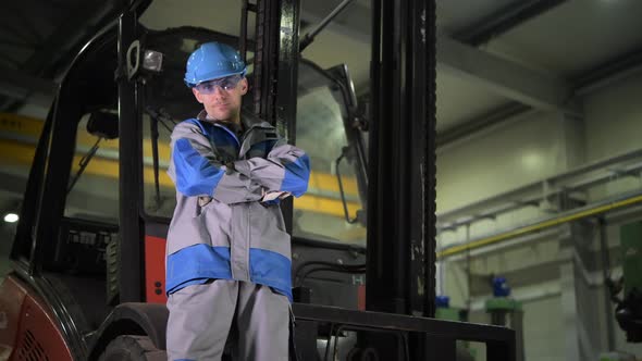 Forklift Operator in His 30s in Front of the Forlift