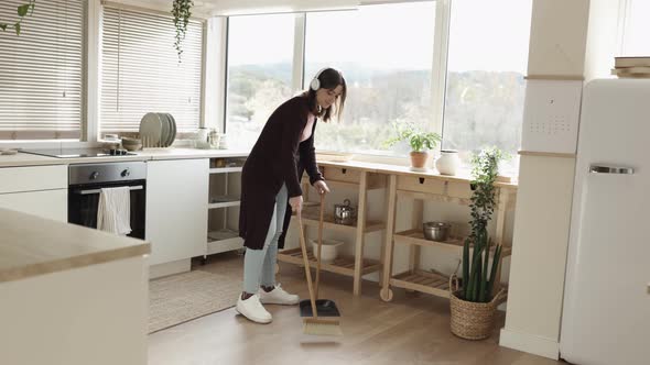 Woman Cleaning the Floor in the Domestic Kitchen