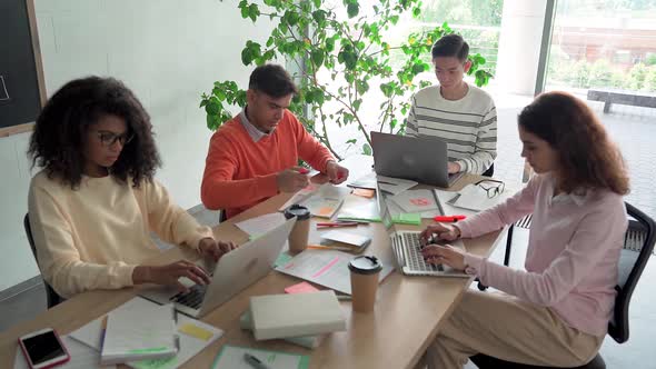 Four Happy Students Creative Team Giving High Five in Classroom Office