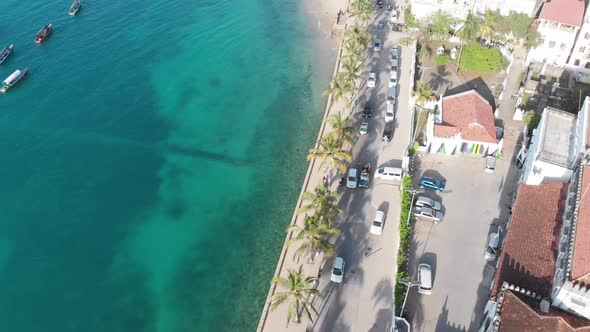 Aerial Stone Town Embankment with Palms Seaport with Boats in Ocean Zanzibar