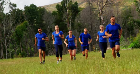 Fit people jogging in boot camp 4k