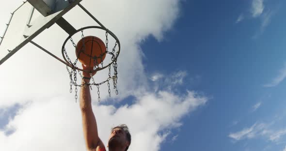 Basketball player scoring a dunk