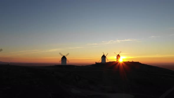 Aerial view of windmills in the countryside in Spain at sunrise