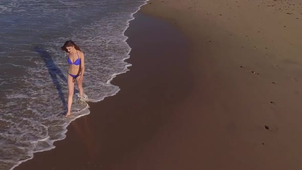 Woman Walking On The Beach