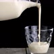 Person pours fermented baked milk from a jug into a glass. - VideoHive Item for Sale