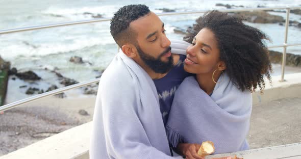 Couple having ice cream cone at beach 4k