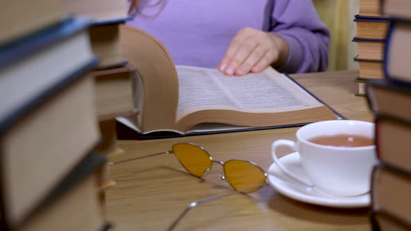 Female Hand Flipping Through the Pages of a Book Closeup