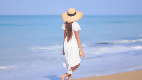 Asian woman enjoy around beautiful beach sea ocean