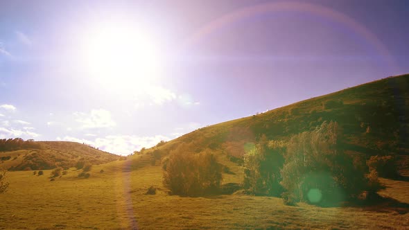  UHD Mountain Meadow Timelapse at the Summer. Clouds, Trees, Green Grass and Sun Rays Movement