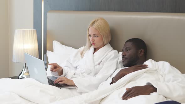 Couple on Bed in Hotel