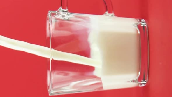 Vertical Video Slow Motion Closeup Shot of Cold Diary Milk Cold Beverage Drink Pooring Into Glass