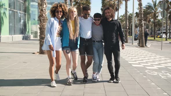 Embracing Happy Friends Walking on Street