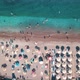 Aerial Top View of Beach with Sunshade and People Swimming at Beautiful Blue Color Sea - VideoHive Item for Sale