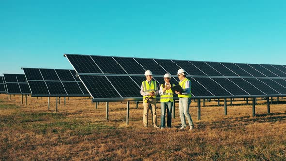 Engineers Near Solar Panels. Solar Power Plant Workers, Solar Energy Industry Concept.