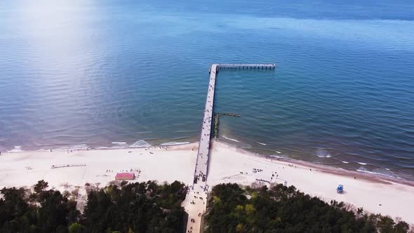 Pedestrian bridge leading into Baltic sea in Palanga, aerial view