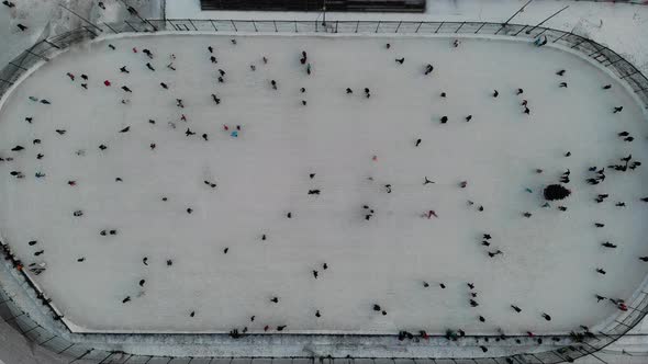 A Lot of People Skate on the Ice Rink in Open Street