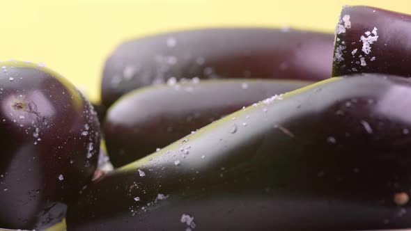 Ripe eggplant on a yellow background