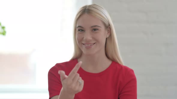 Young Blonde Woman Pointing at the Camera and Inviting
