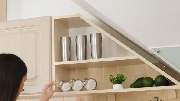 Young Woman Tidies Up in the Kitchen Coziness in the House