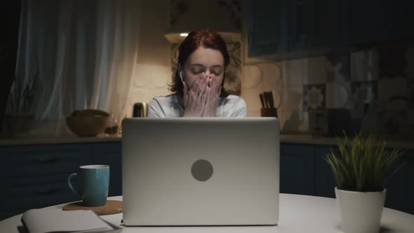 Woman In The Kitchen With Laptop, Woman Tired And Wants To Sleep, She Yawns