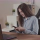 Girl Typing a Message on the Phone Using a Laptop - VideoHive Item for Sale