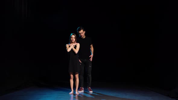 Romantic Choreography Against Black Background in Spotlight at Studio