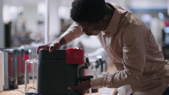 Buying Automatic Coffee Machine in Home Appliance Store Young Black Guy is Shopping in Mall