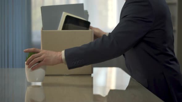 Company Employee Unpacking, Putting His Stuff From Box Onto Desk, New Position