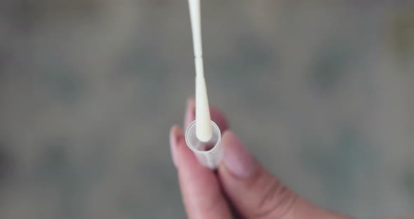 Hand Placed And Rotate Specimen On Nasopharyngeal Swab Inside The Tube For COVID-19 Testing. - high