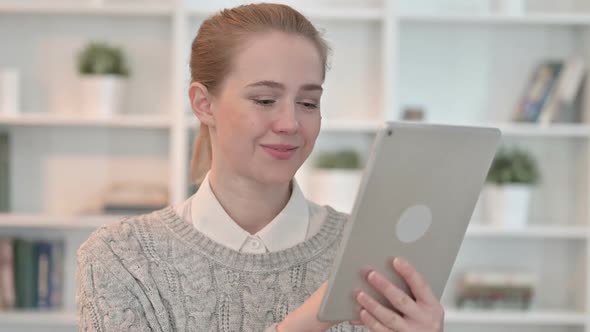 Portrait of Attractive Young Woman Using Tablet