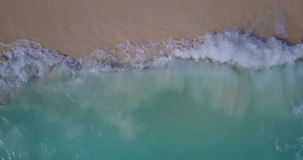 Daytime aerial abstract shot of a paradise sunny white sand beach and aqua blue ocean background in 