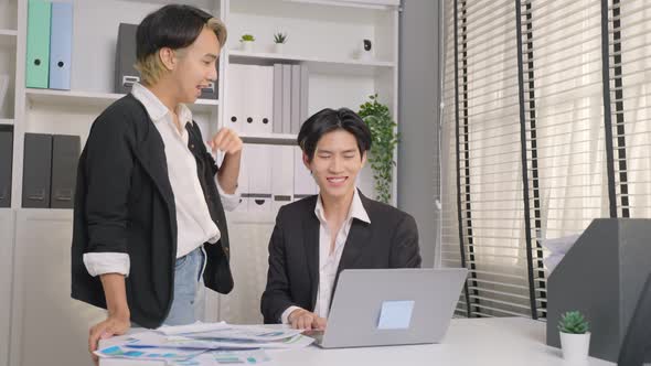 Asian handsome businessman gay people working in office with happiness.