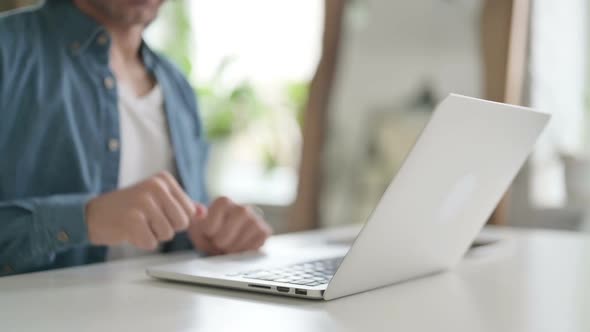 Close Up of Male Hand Using Laptop Showing Thumbs Down