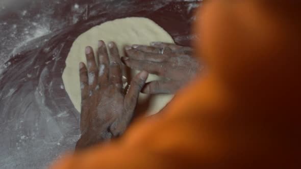 one boy prepare dough for pizza