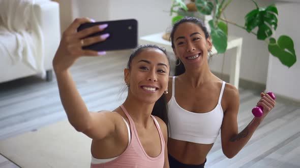 Female Athletes Posing and Taking Selfie Photo During Fitness Training at Home Interior