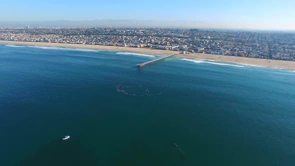 Aerial shot of surfers paddling out on the ocean.