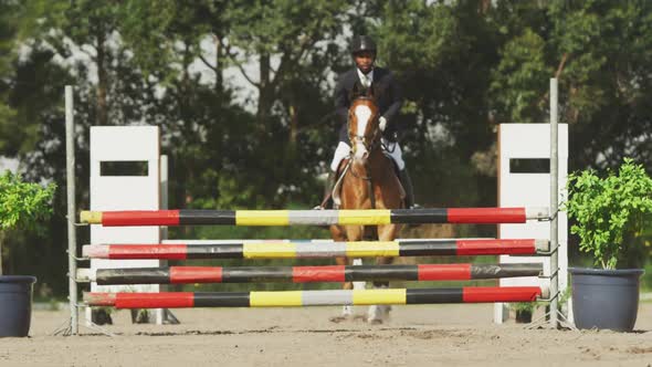 African American man jumping an obstacle with his Dressage horse