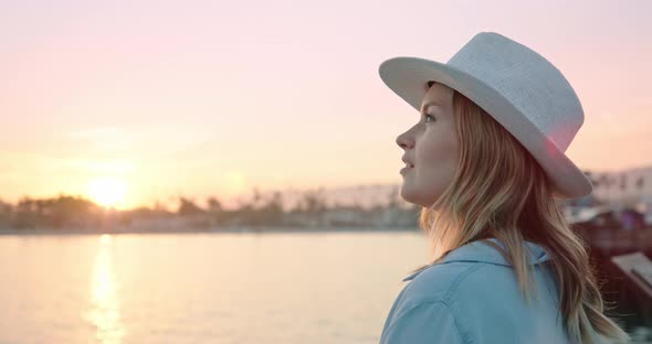 Close Up Portrait of Smiling Woman Enjoying Beautiful Rose Gold Sunset at Ocean