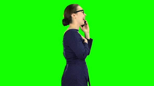 Woman Is Going To a Meeting and Talking on the Phone. Green Screen. Side View