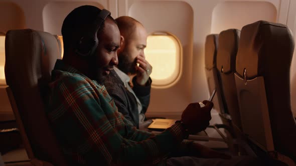 Diverse Passengers Chatting with Stewardess on Commercial Flight