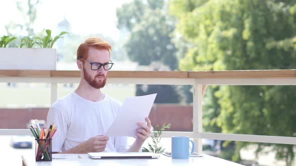 Paperwork, Reading, Designer Sitting in Balcony of Office Outdoor