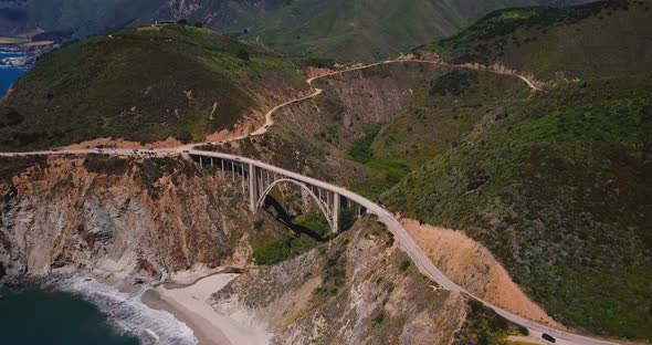 Amazing Cinematic Aerial Shot of Famous Bixby Canyon Bridge and Highway 1 Sunny Summer Panorama