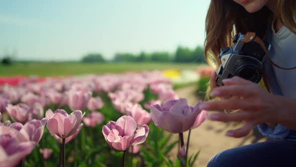 Closeup Beautiful Woman Taking Photo with Professional Camera in Flower Field